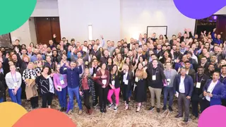 A large group photo of Planful employees smiling and waving.